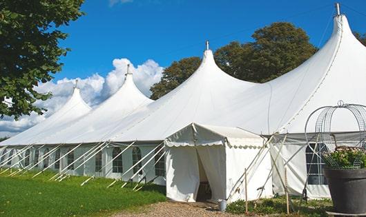 a row of portable restrooms placed outdoors for attendees of a special event in Kodak